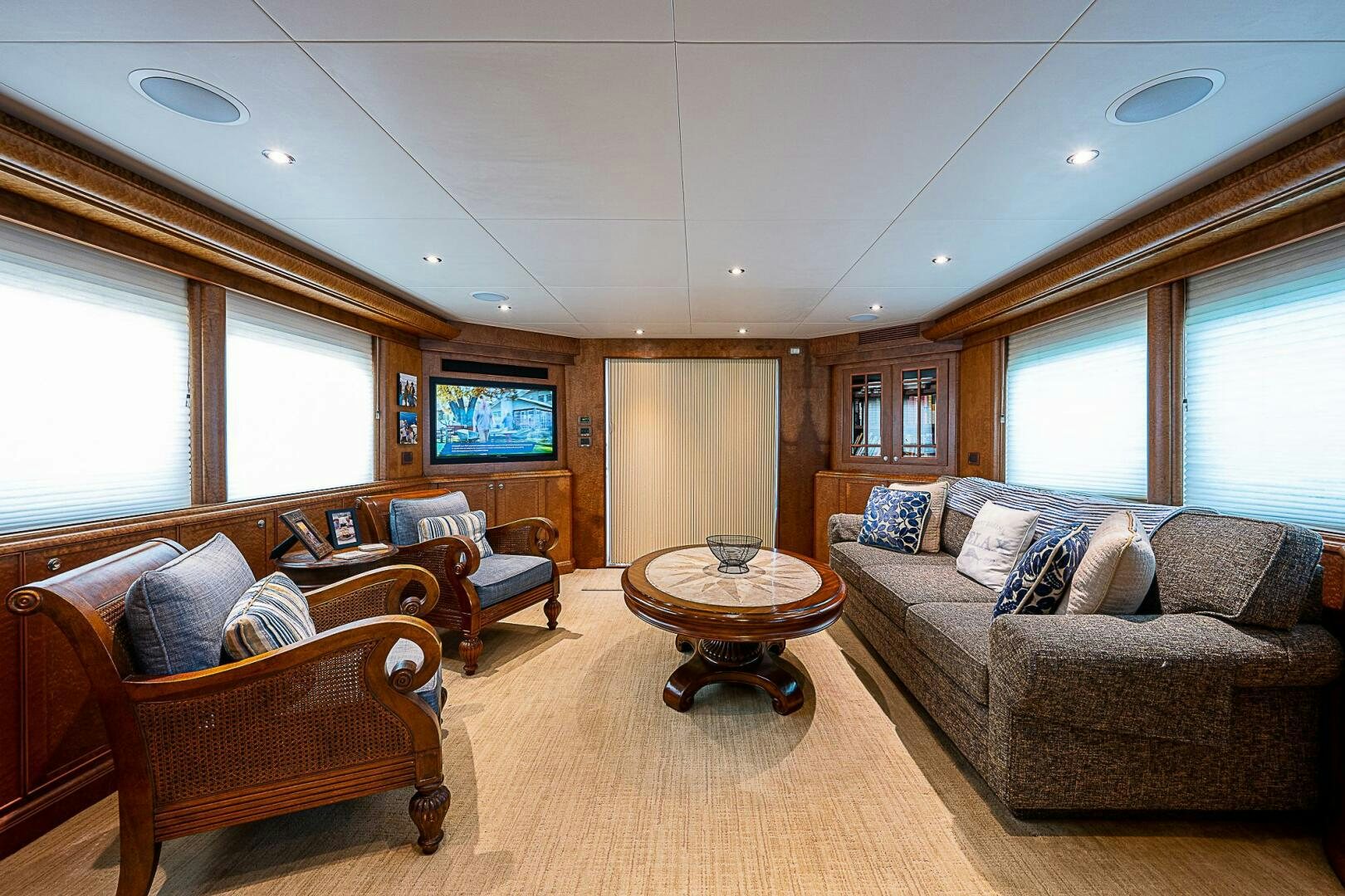 a living room with a couch and a coffee table aboard PREDATOR Yacht for Sale