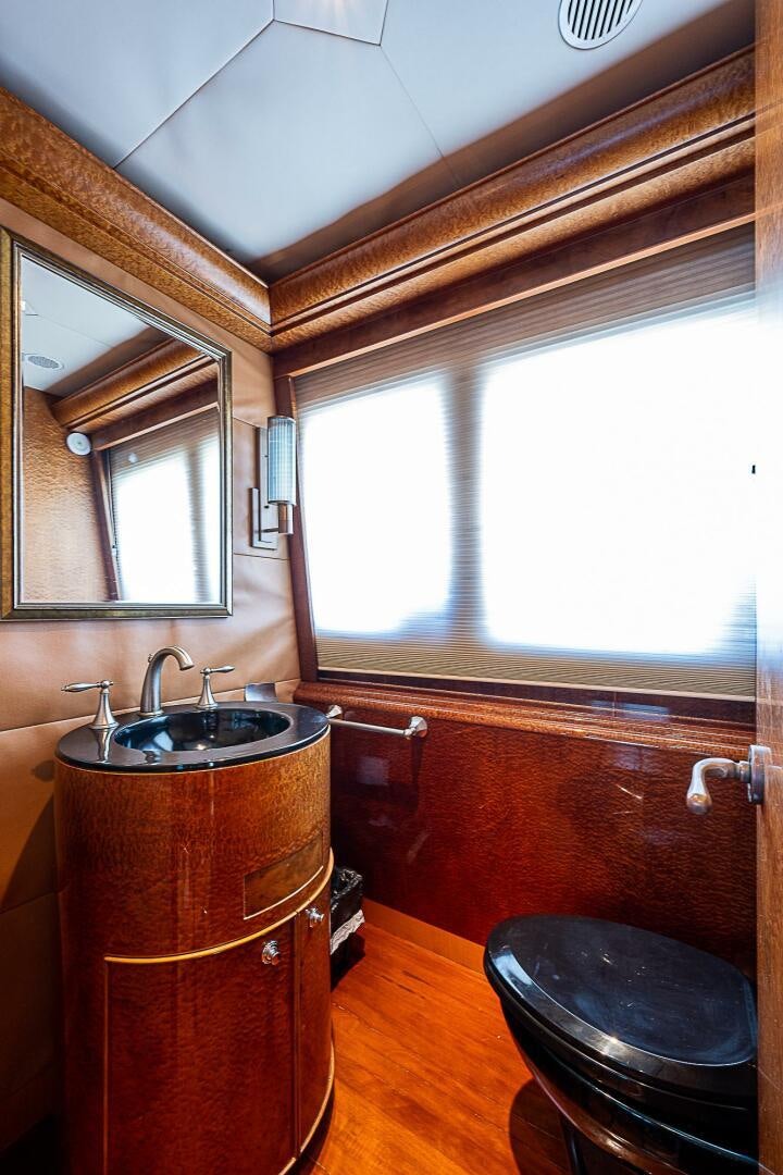 a bathroom with a sink and a mirror aboard PREDATOR Yacht for Sale