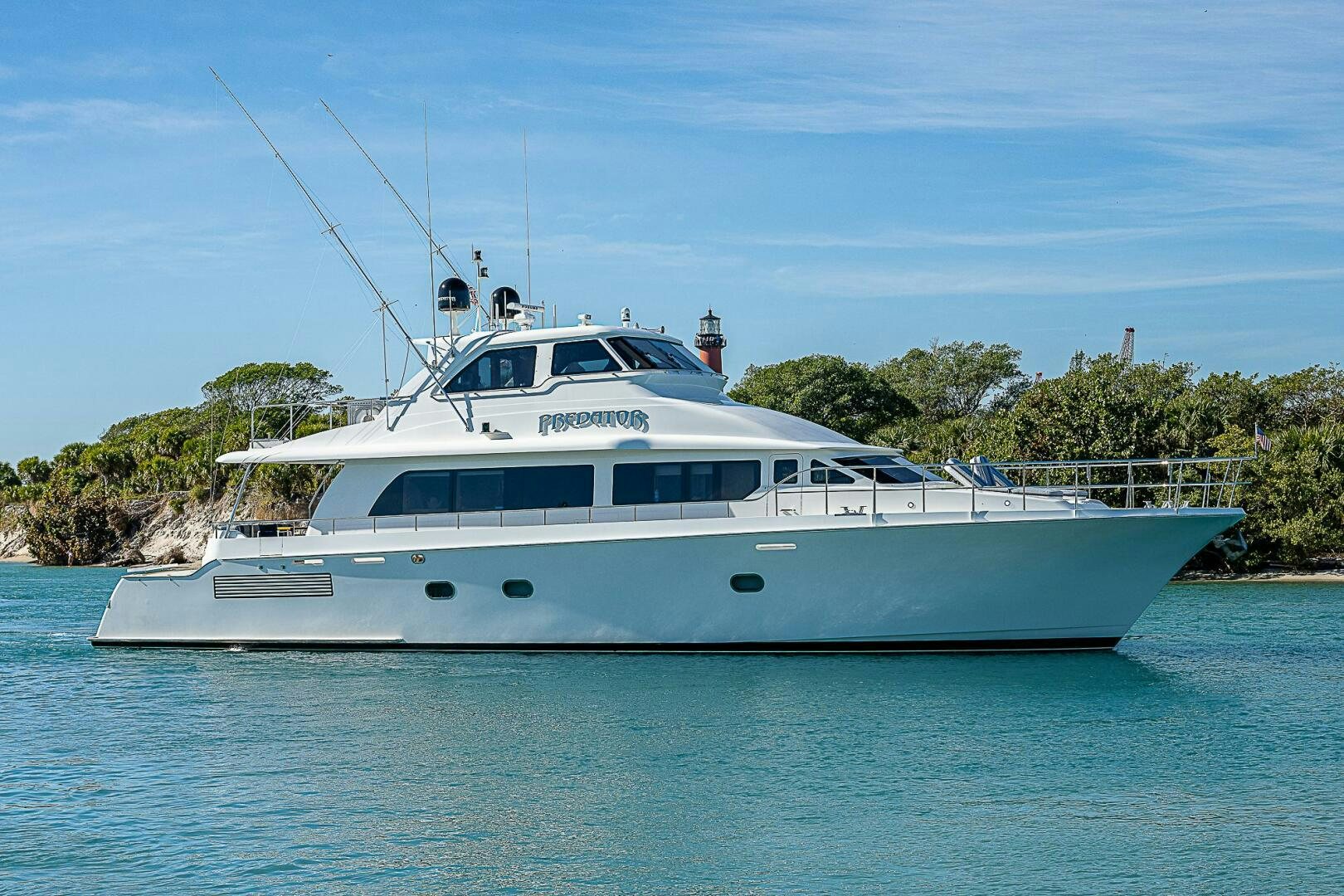 a white boat on water aboard PREDATOR Yacht for Sale