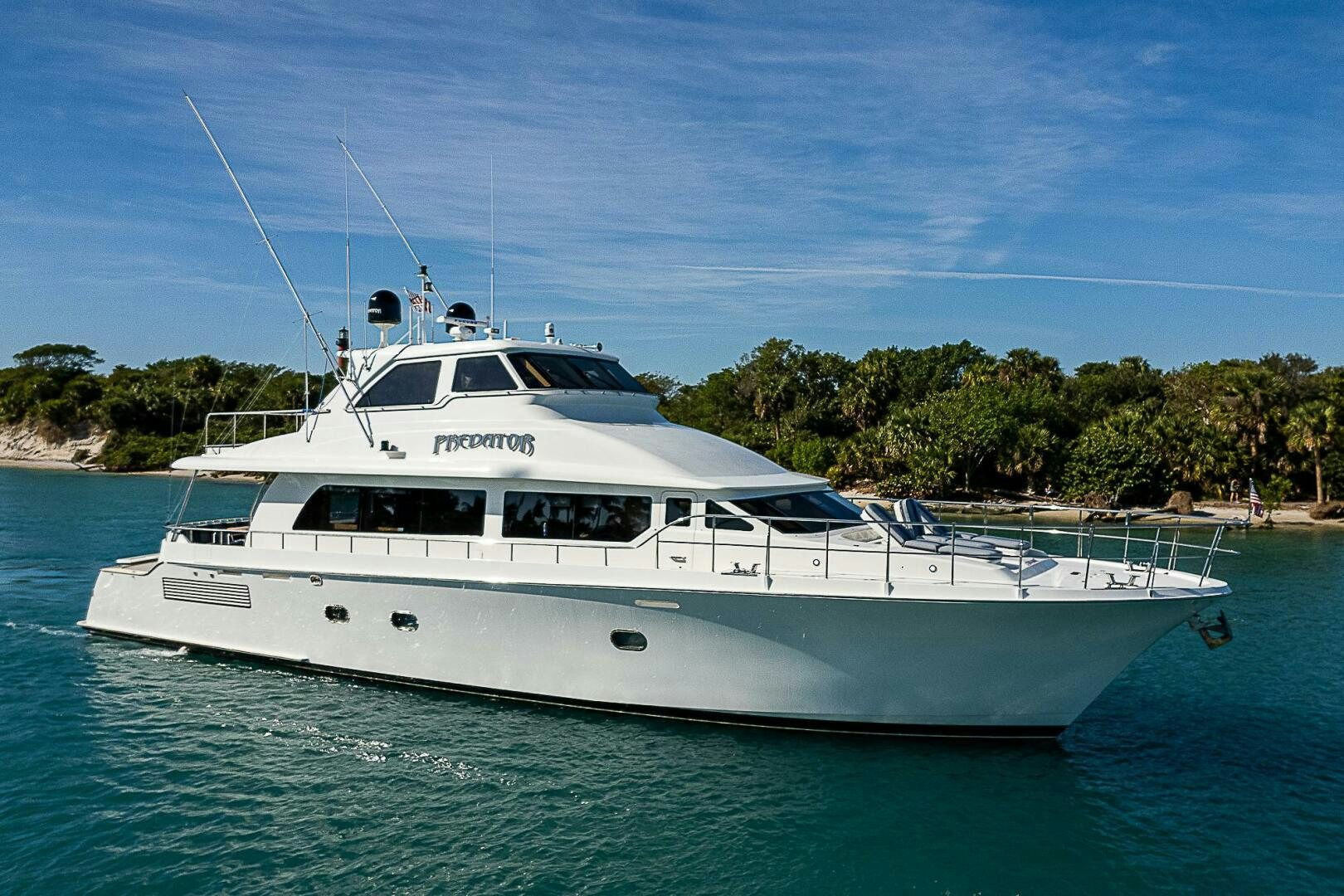a white yacht in the water aboard PREDATOR Yacht for Sale
