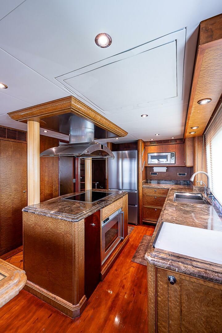 a kitchen with a stove and a sink aboard PREDATOR Yacht for Sale