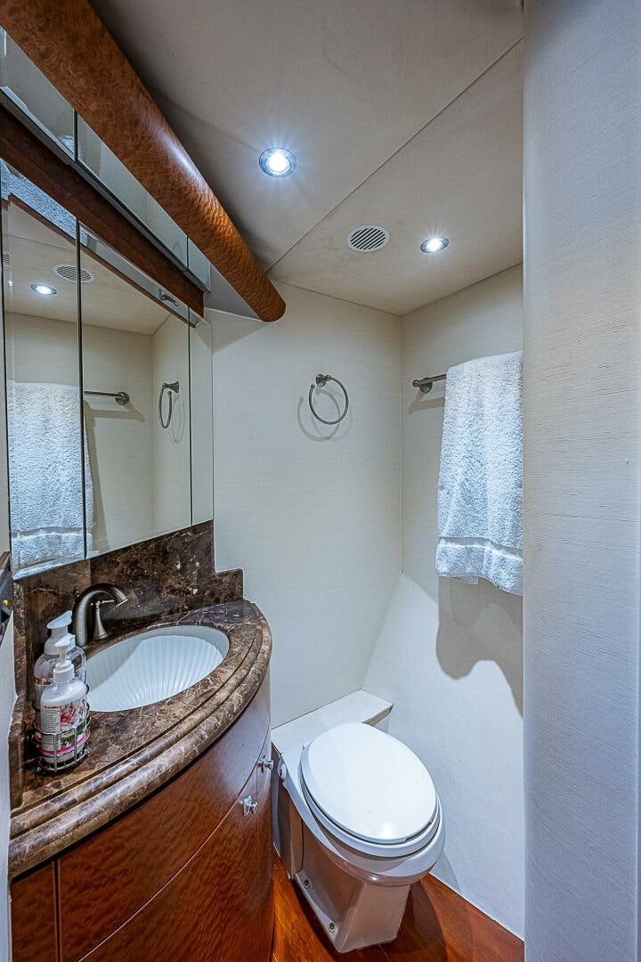 a bathroom with a sink and toilet aboard PREDATOR Yacht for Sale