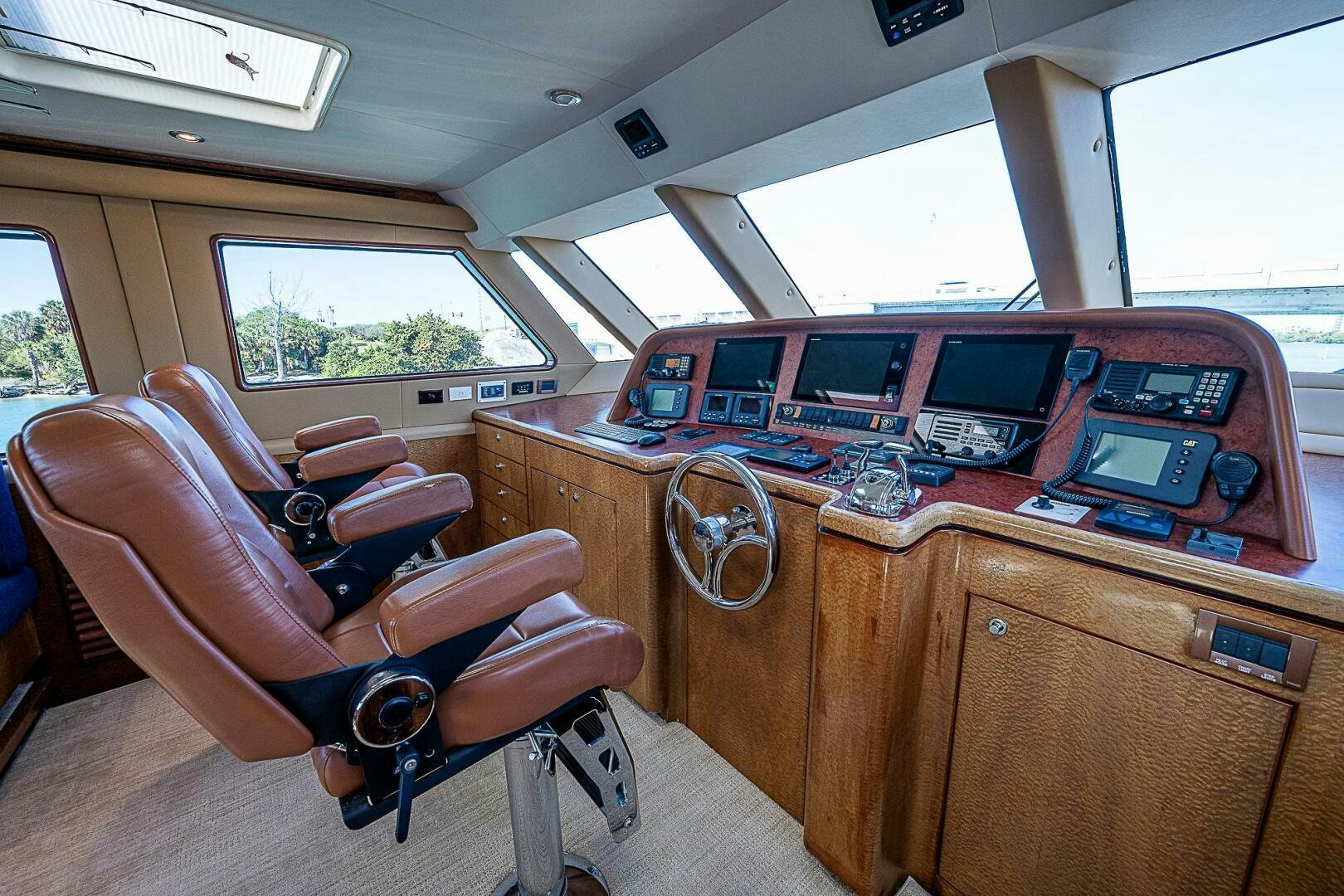 a wooden desk with chairs and a computer on it aboard PREDATOR Yacht for Sale