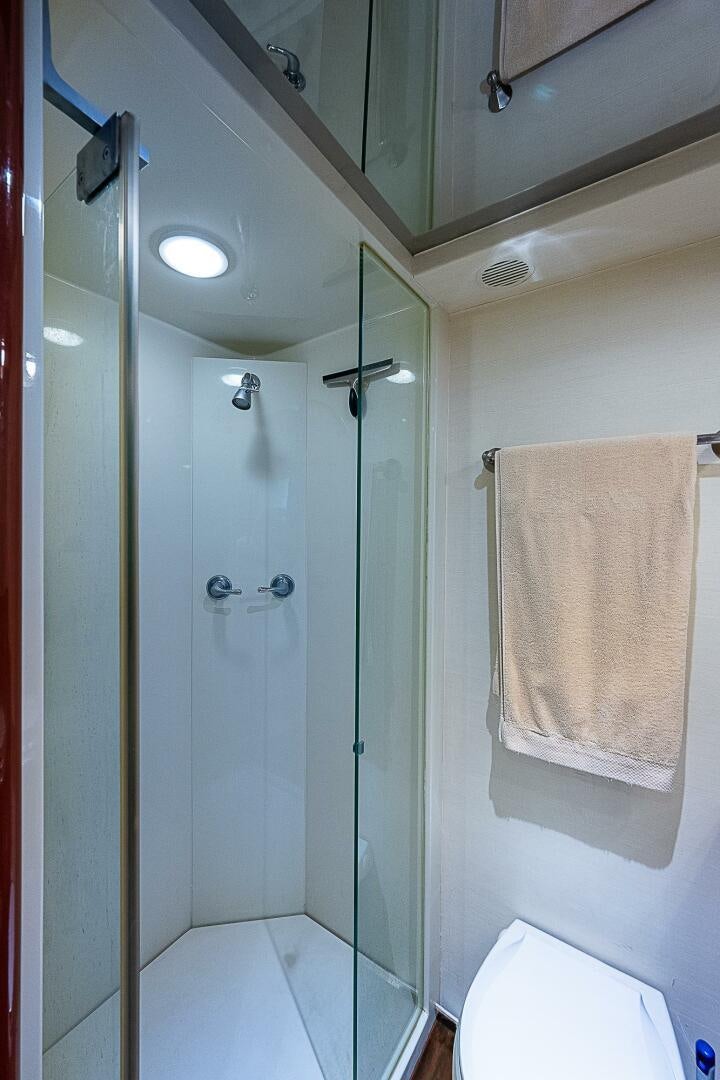 a bathroom with a shower and a towel on the wall aboard PREDATOR Yacht for Sale
