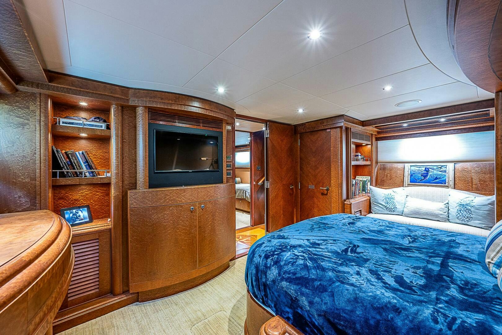 a bedroom with a bed and a tv aboard PREDATOR Yacht for Sale