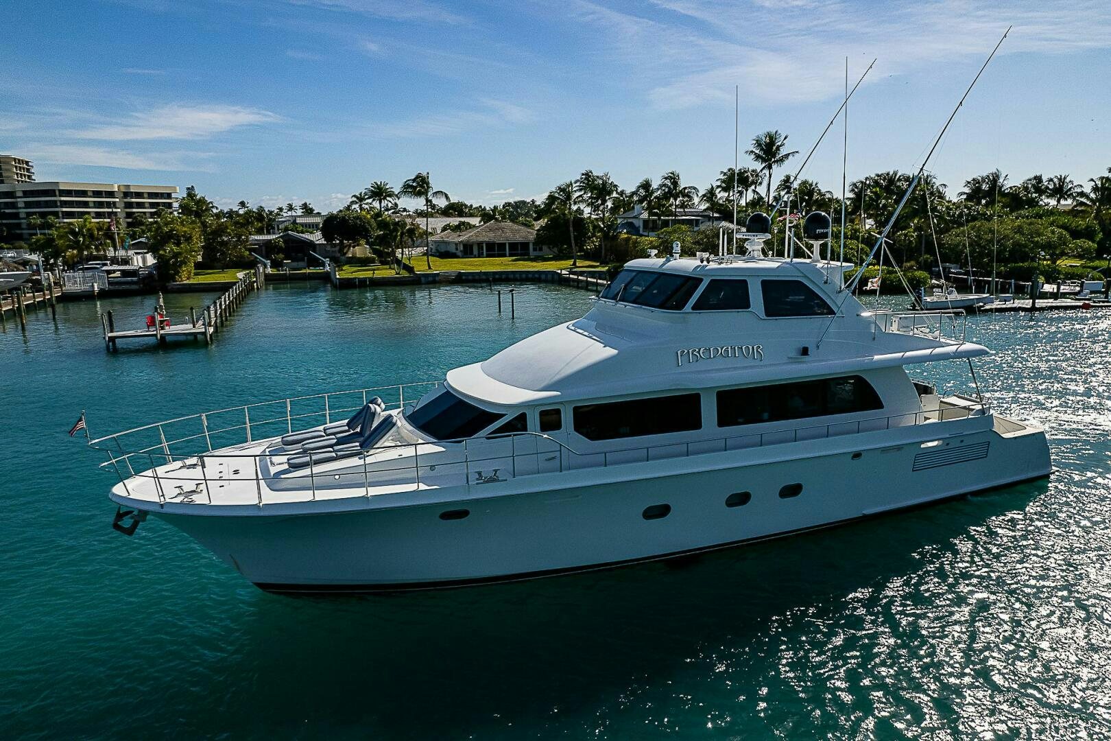 a white yacht in a harbor aboard PREDATOR Yacht for Sale