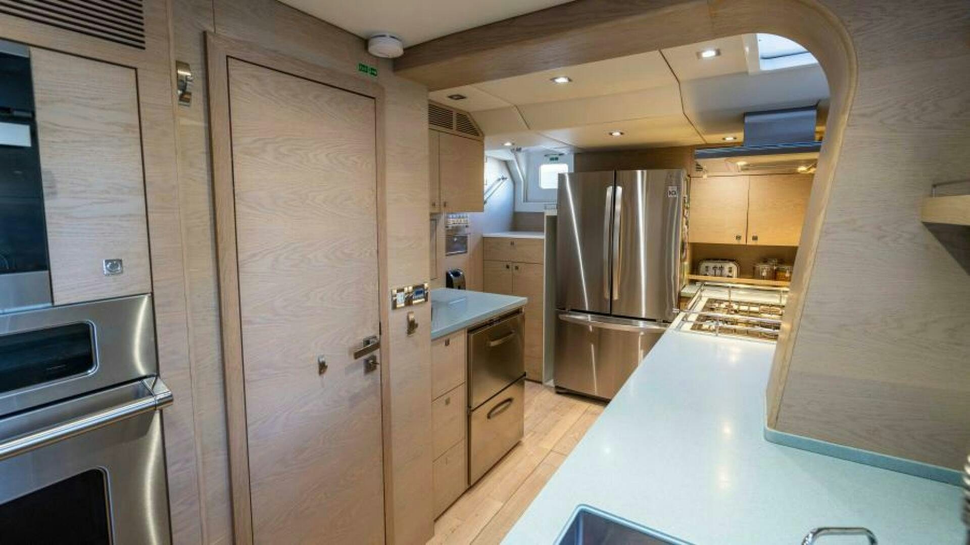 a kitchen with a large refrigerator aboard WILDBERRY Yacht for Sale