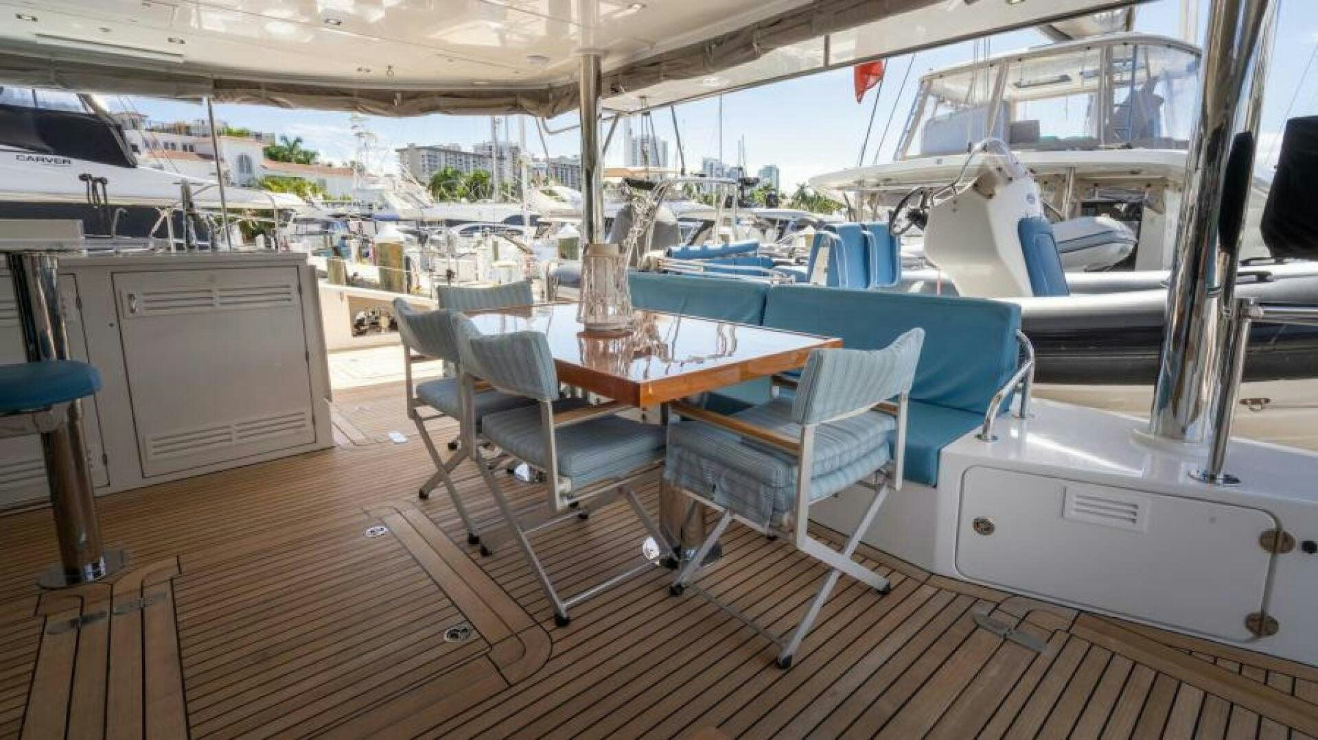 a boat with tables and chairs aboard WILDBERRY Yacht for Sale