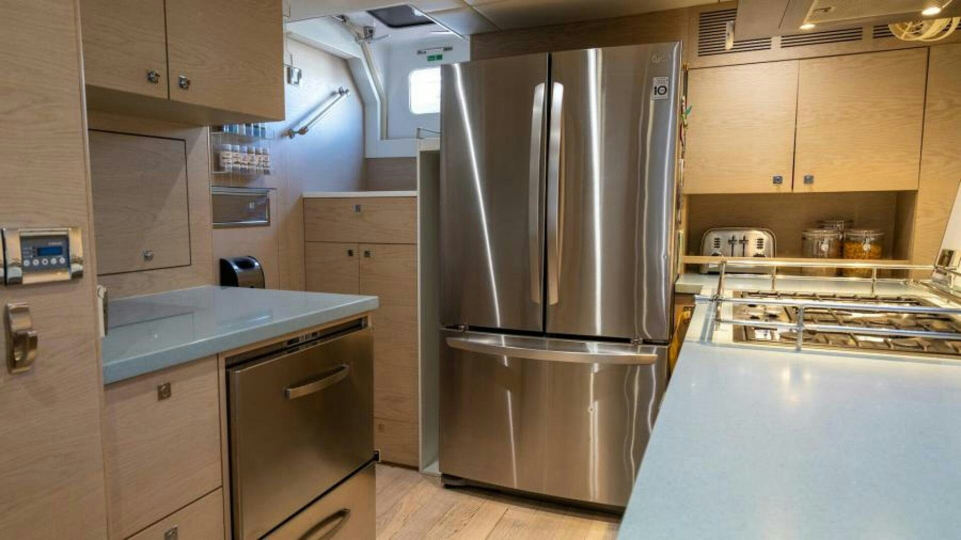 a kitchen with a stainless steel refrigerator aboard WILDBERRY Yacht for Sale