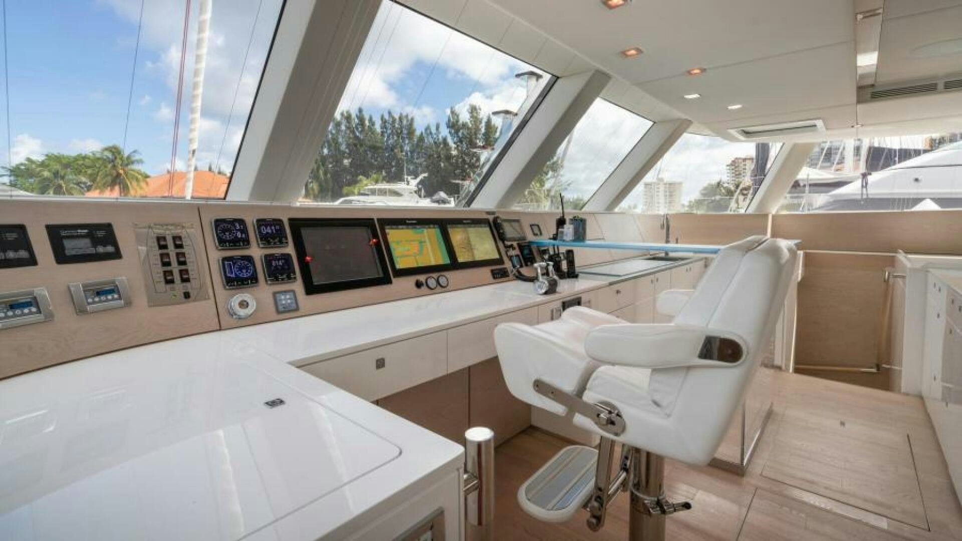 a room with a chair and a table with a computer on it aboard WILDBERRY Yacht for Sale