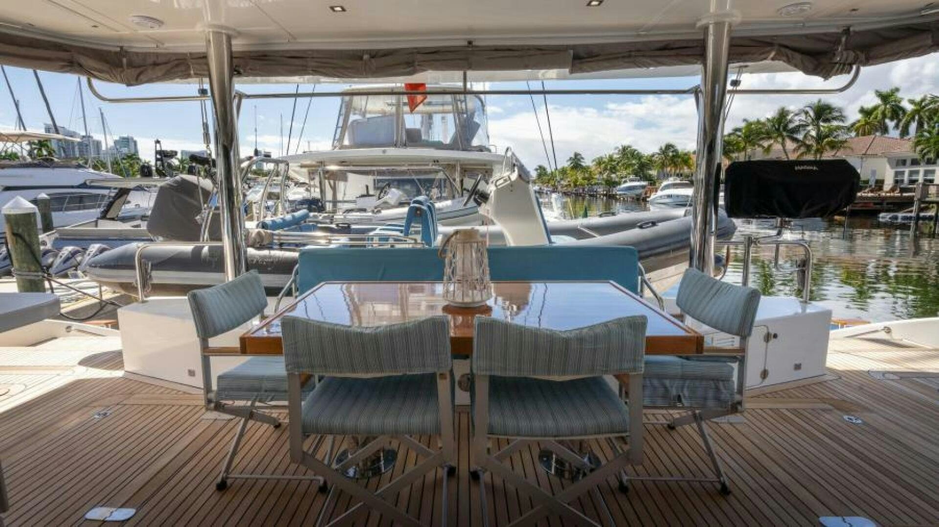 a deck with a table chairs and a pool aboard WILDBERRY Yacht for Sale