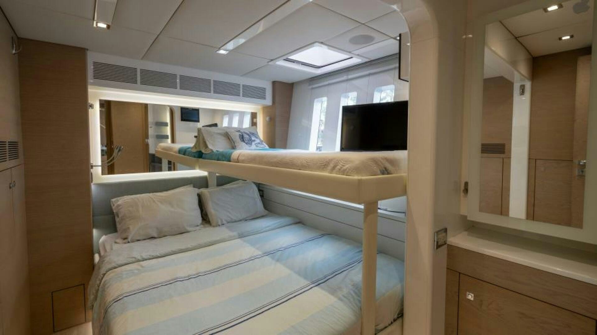 a room with a bed and a tv aboard WILDBERRY Yacht for Sale