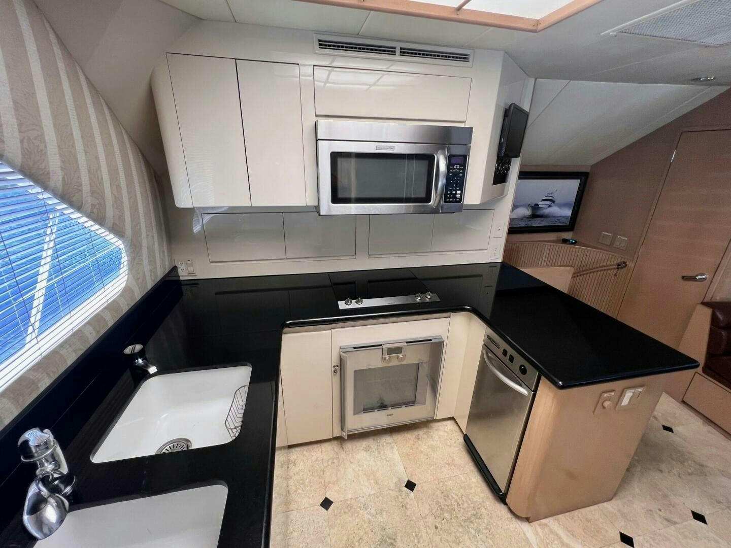 a kitchen with a microwave oven and a sink aboard SEAQUEST Yacht for Sale