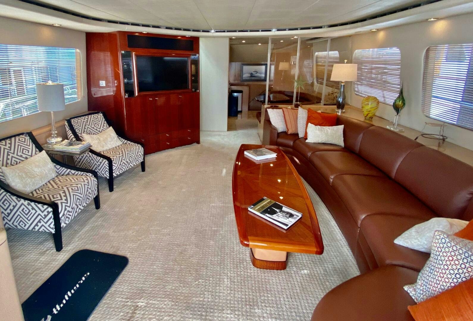 a living room with a red couch and a red table aboard SEAQUEST Yacht for Sale