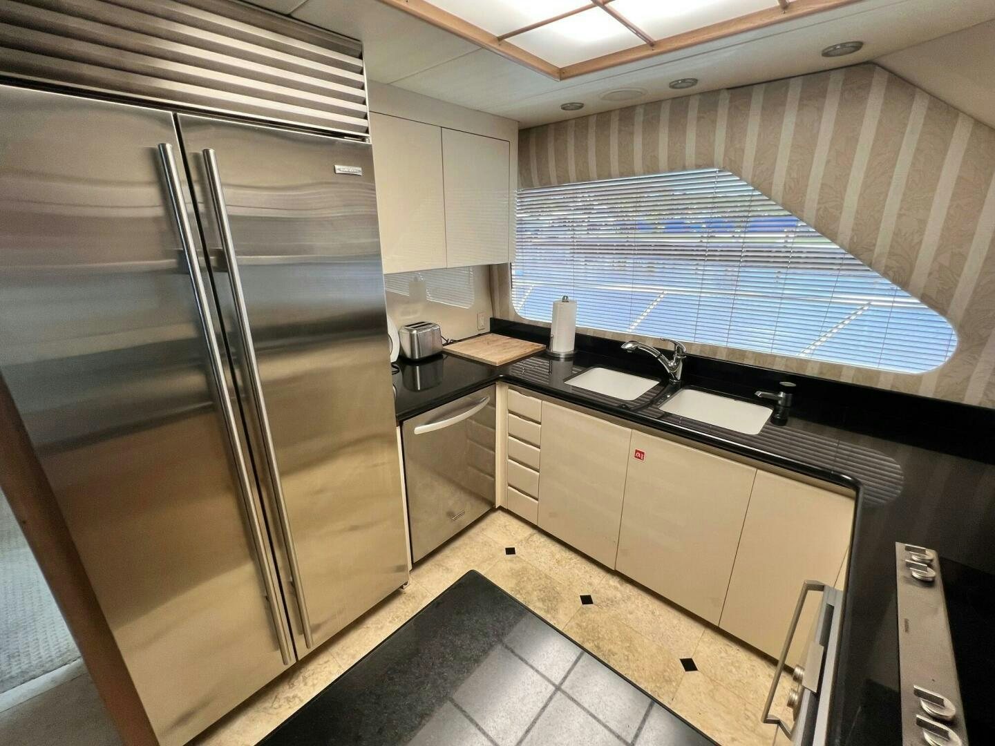 a kitchen with a stainless steel refrigerator aboard SEAQUEST Yacht for Sale
