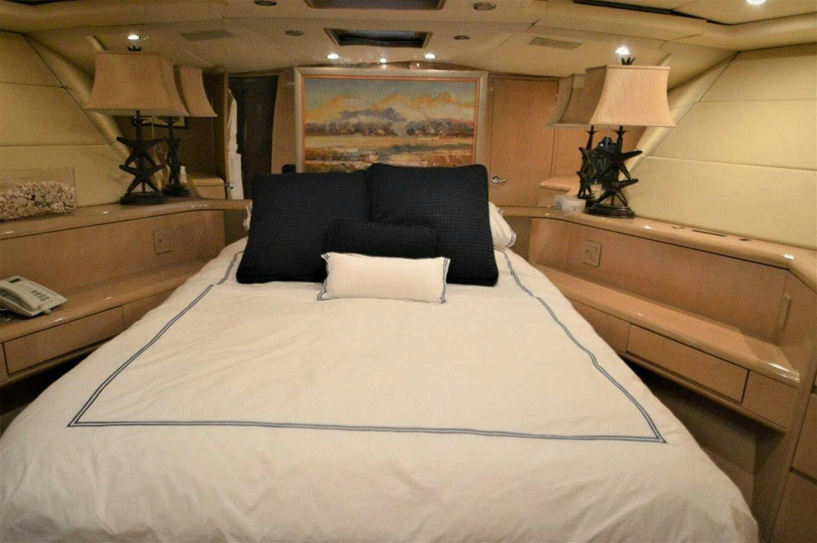 a bed with a white sheet and pillows aboard SEAQUEST Yacht for Sale