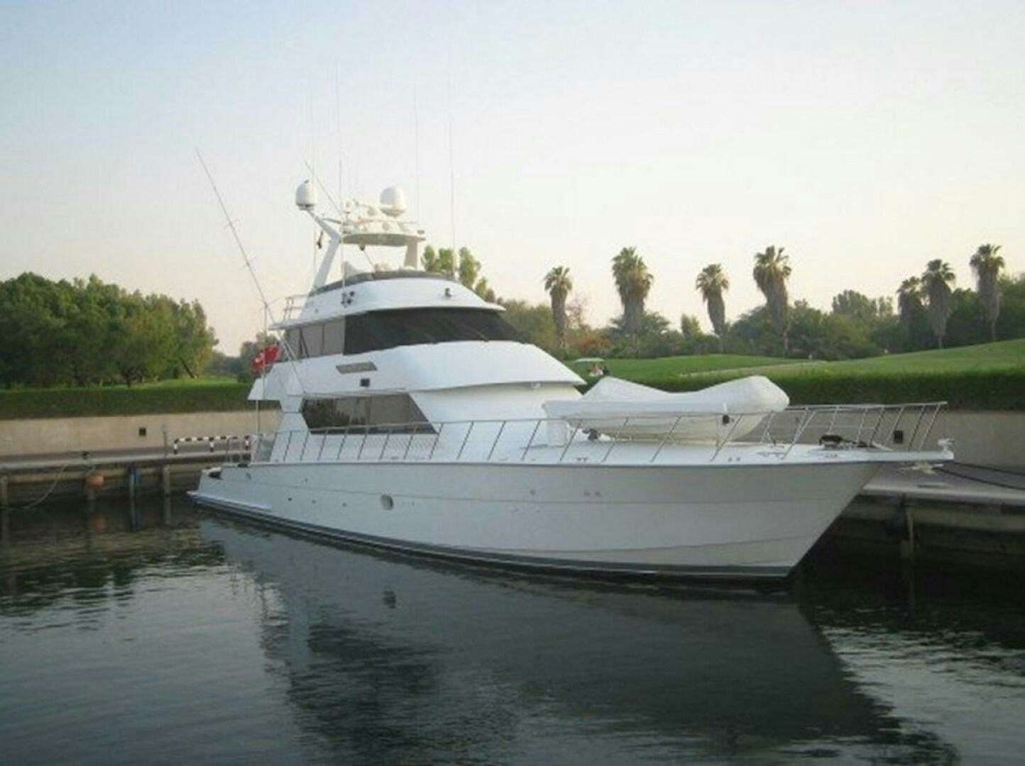 a white boat on a body of water aboard SEAQUEST Yacht for Sale