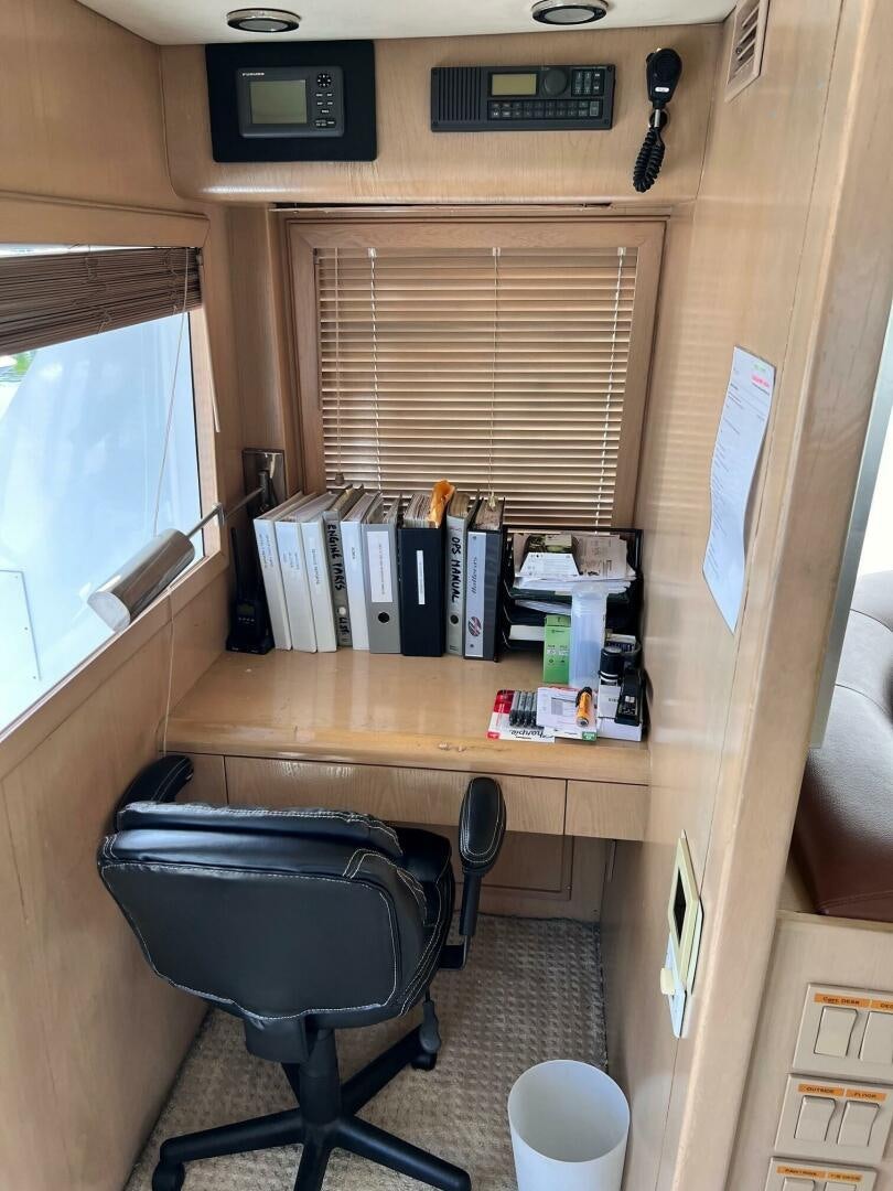 a desk with a chair and a computer on it aboard SEAQUEST Yacht for Sale