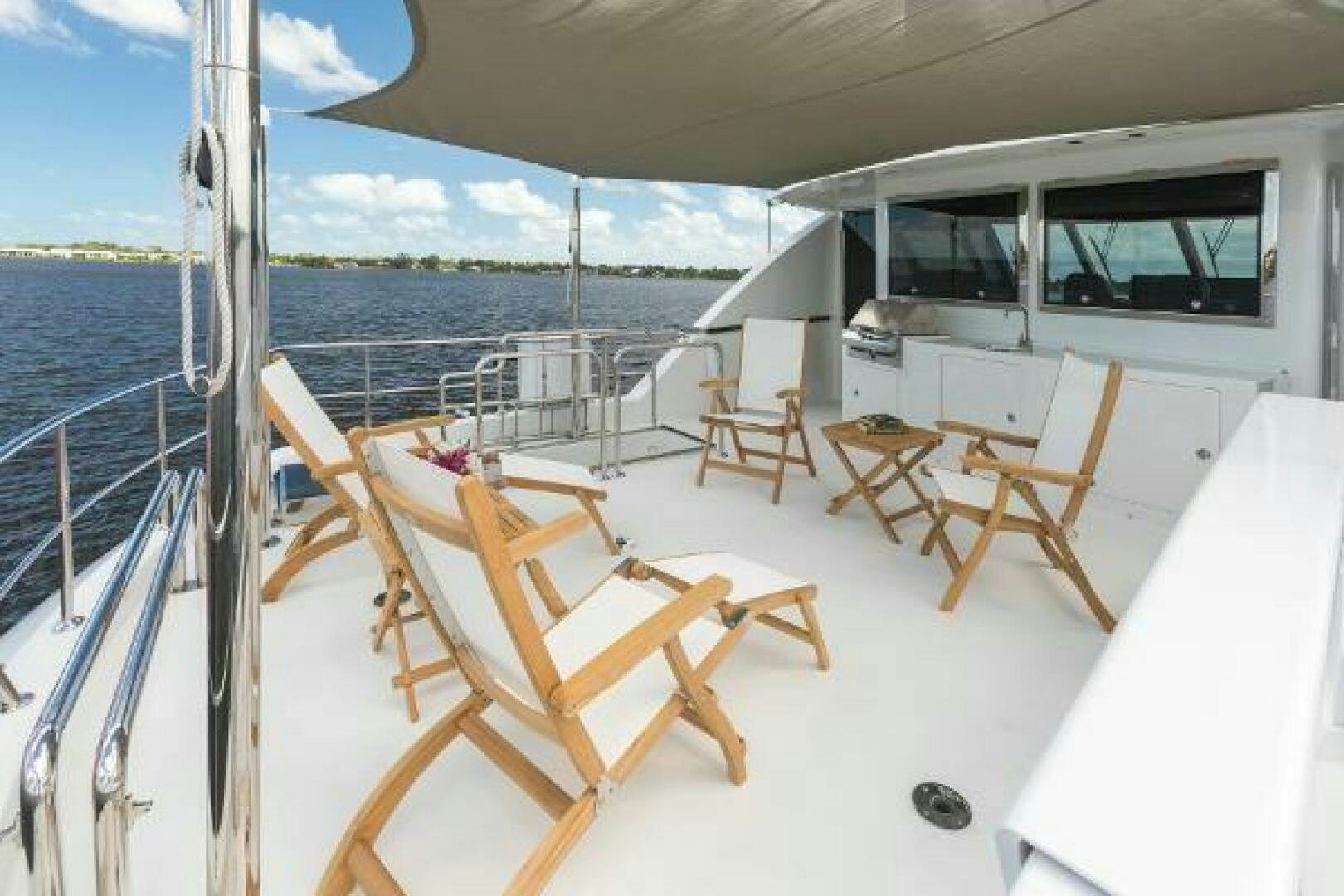 a deck with chairs and tables on it aboard JANE E Yacht for Sale
