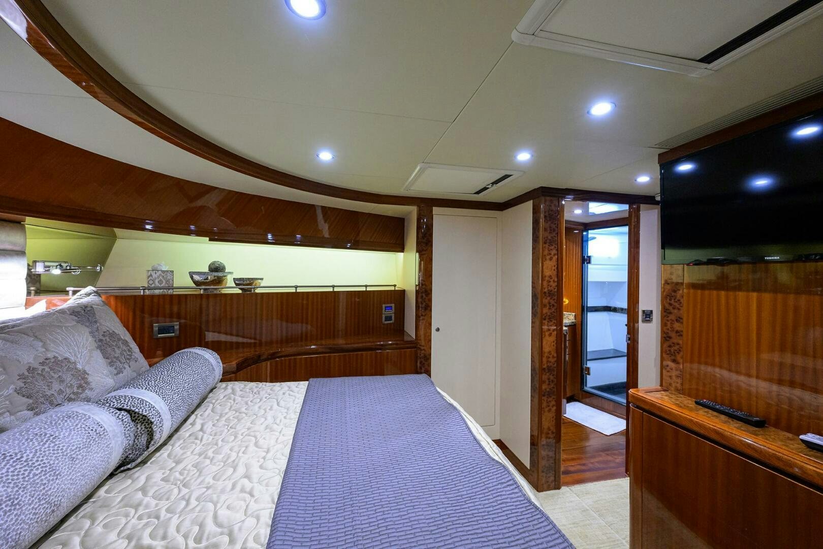 a bedroom with a bed and a wood door aboard JANE E Yacht for Sale