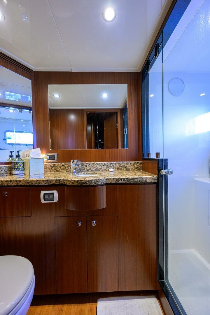 a bathroom with a countertop sink and cabinets aboard JANE E Yacht for Sale