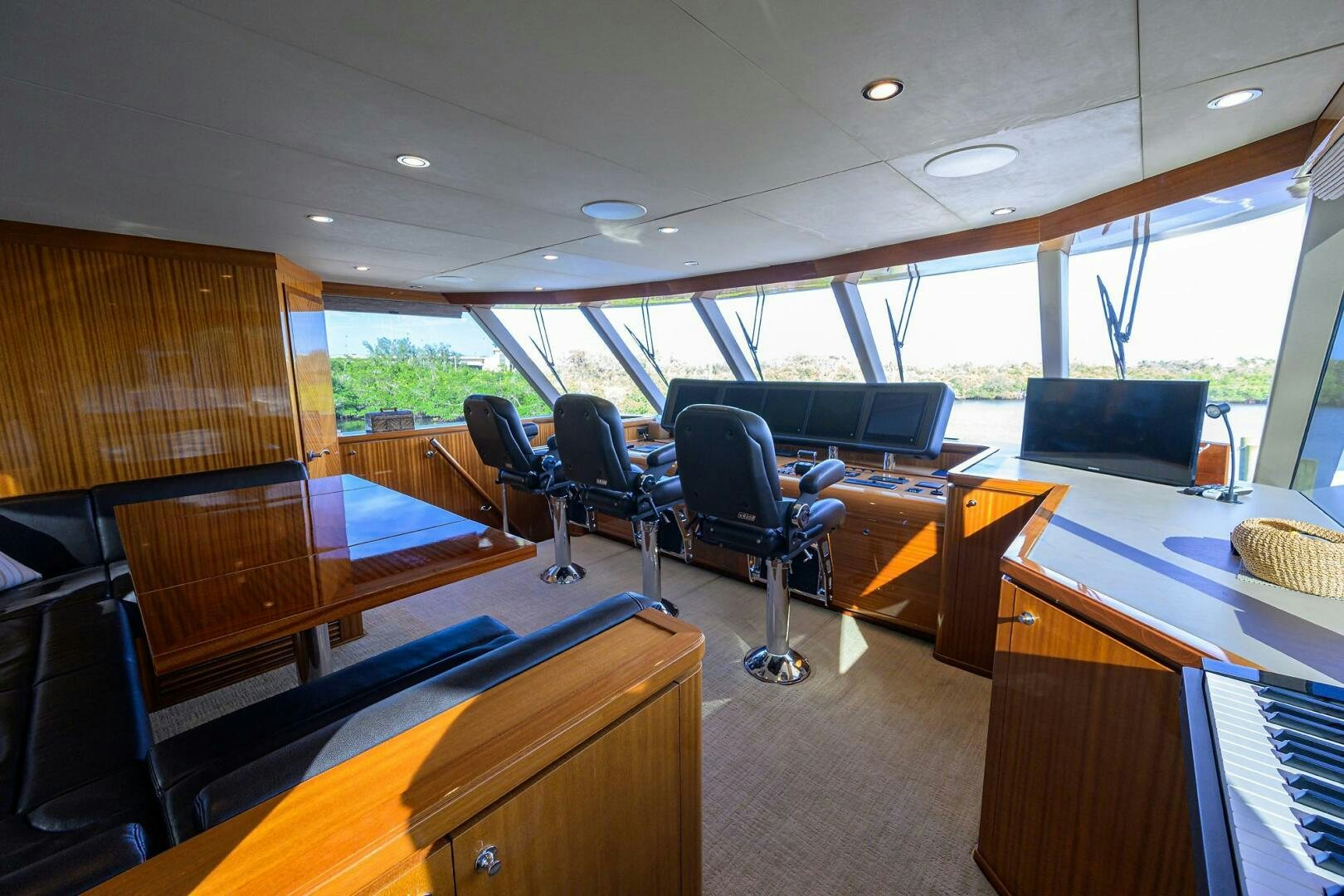 inside view of a room with a large window and a large table with chairs and a large window aboard JANE E Yacht for Sale