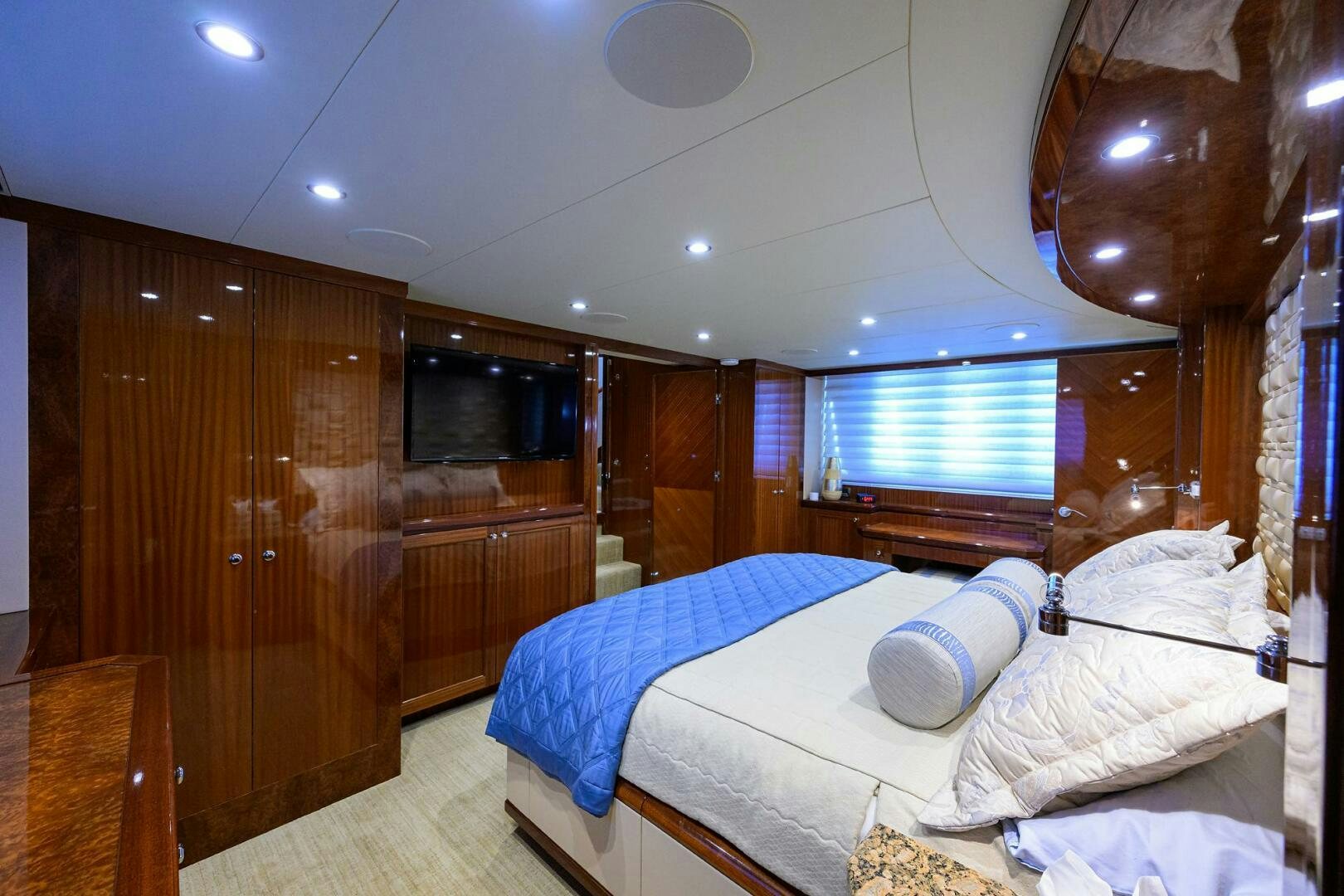 a room with a bed and a wood door aboard JANE E Yacht for Sale