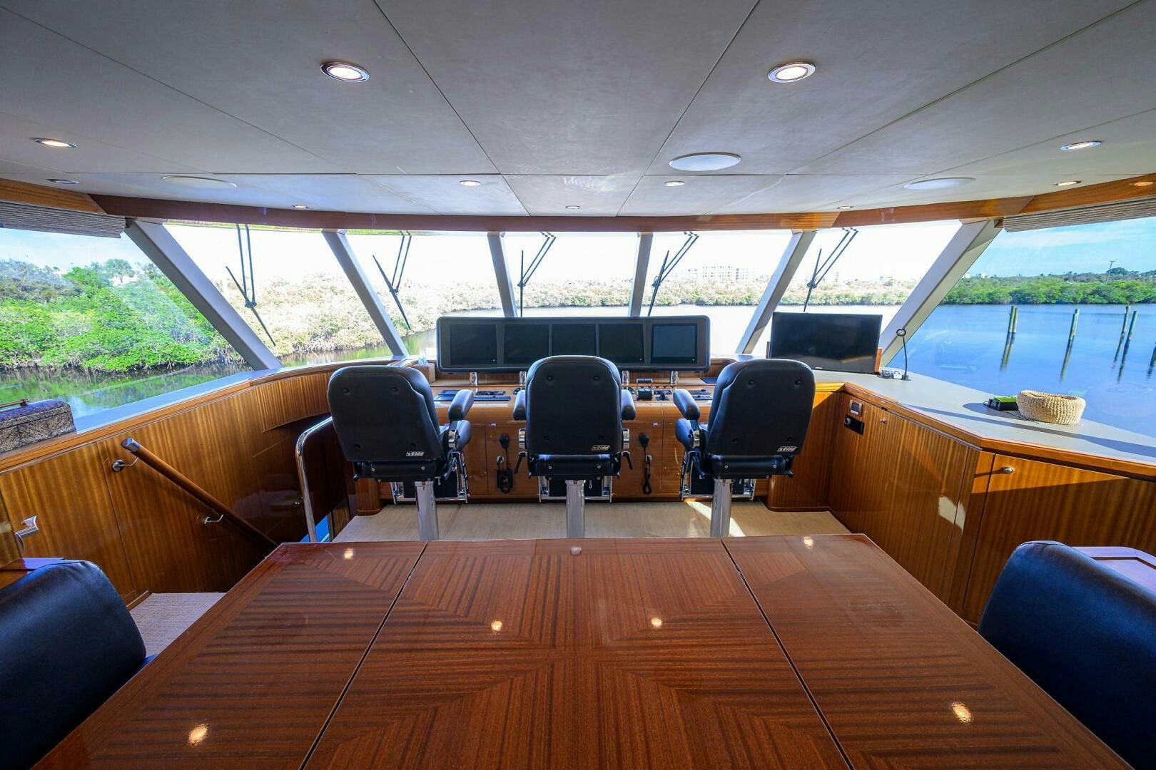 inside of a vehicle with chairs and tables and a large window aboard JANE E Yacht for Sale