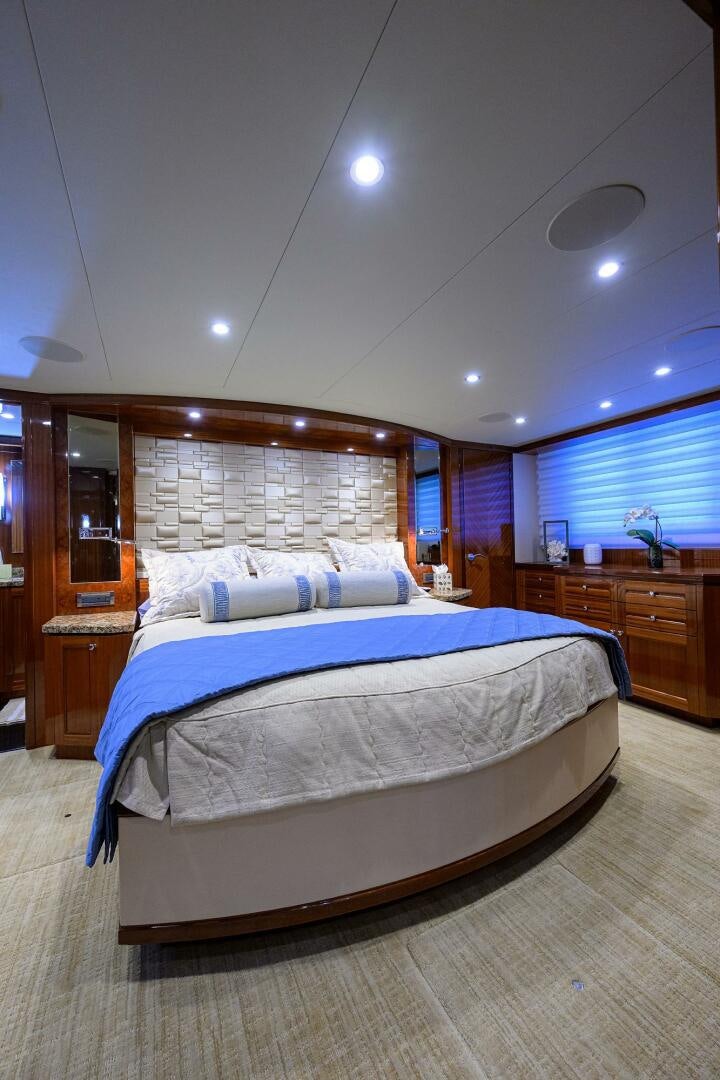 a bedroom with a bed and a desk aboard JANE E Yacht for Sale