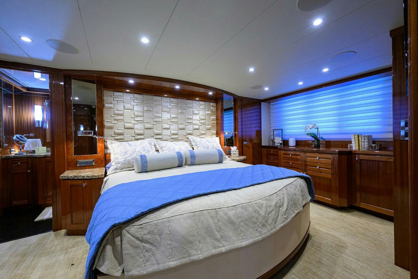 a bedroom with a bed and cabinets aboard JANE E Yacht for Sale