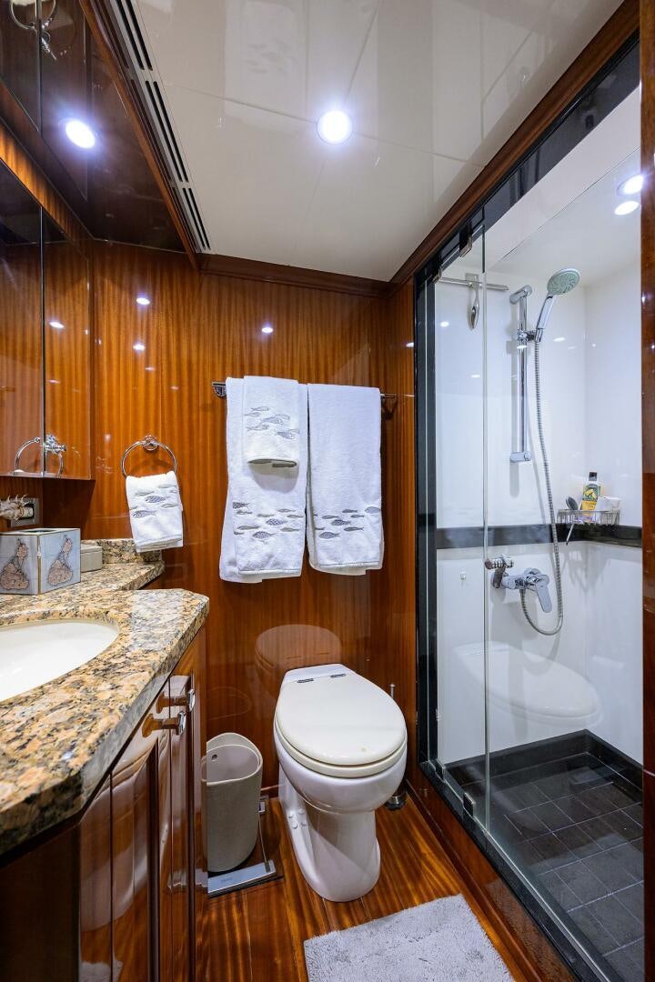 a bathroom with a shower sink and toilet aboard JANE E Yacht for Sale