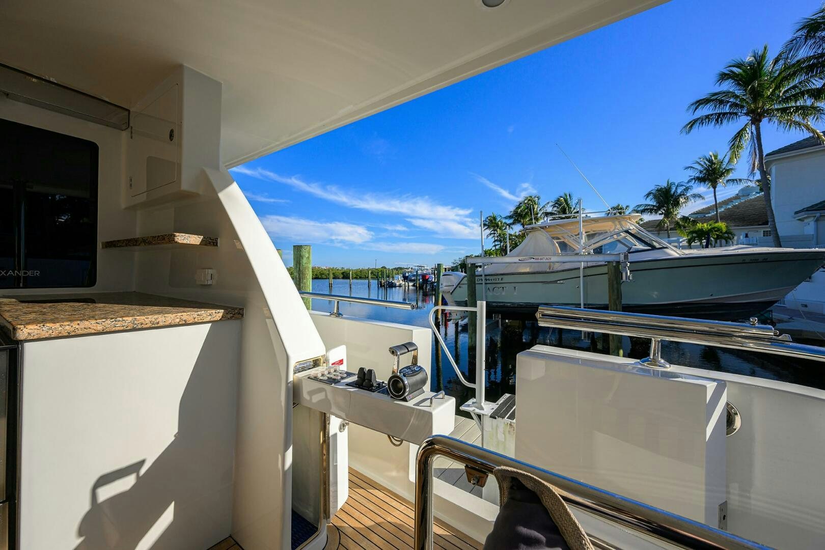 a deck with a pool and a beach aboard JANE E Yacht for Sale