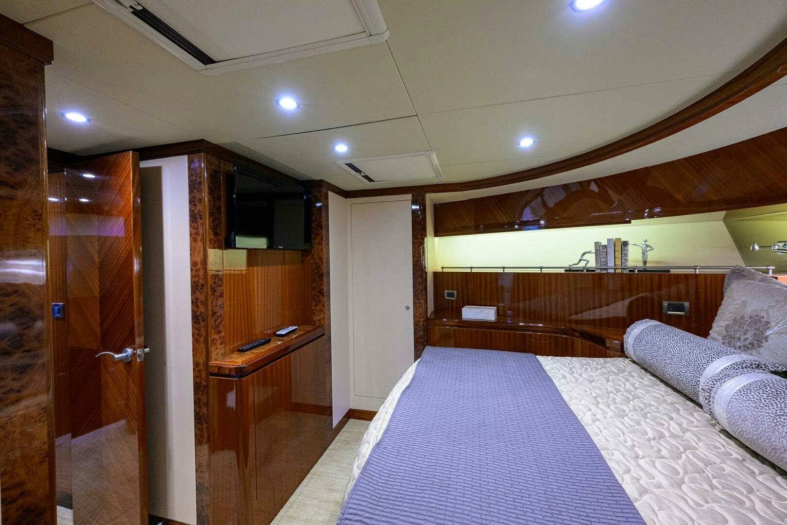 a bedroom with a bed and a desk aboard JANE E Yacht for Sale