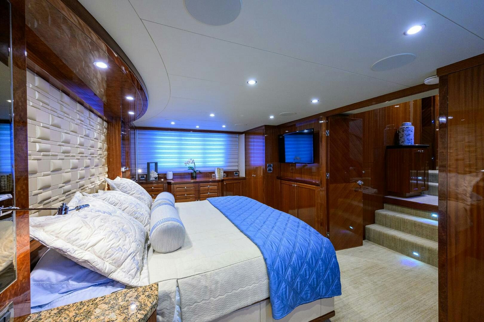 a bedroom with a bed and a wood door aboard JANE E Yacht for Sale