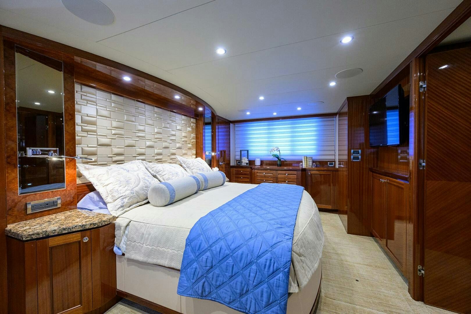 a bedroom with a bed and a television aboard JANE E Yacht for Sale