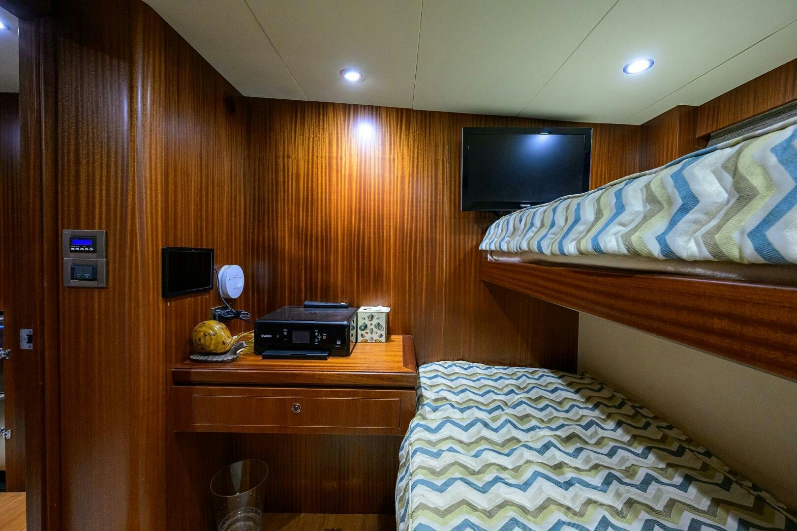 a room with a bed and a television aboard JANE E Yacht for Sale