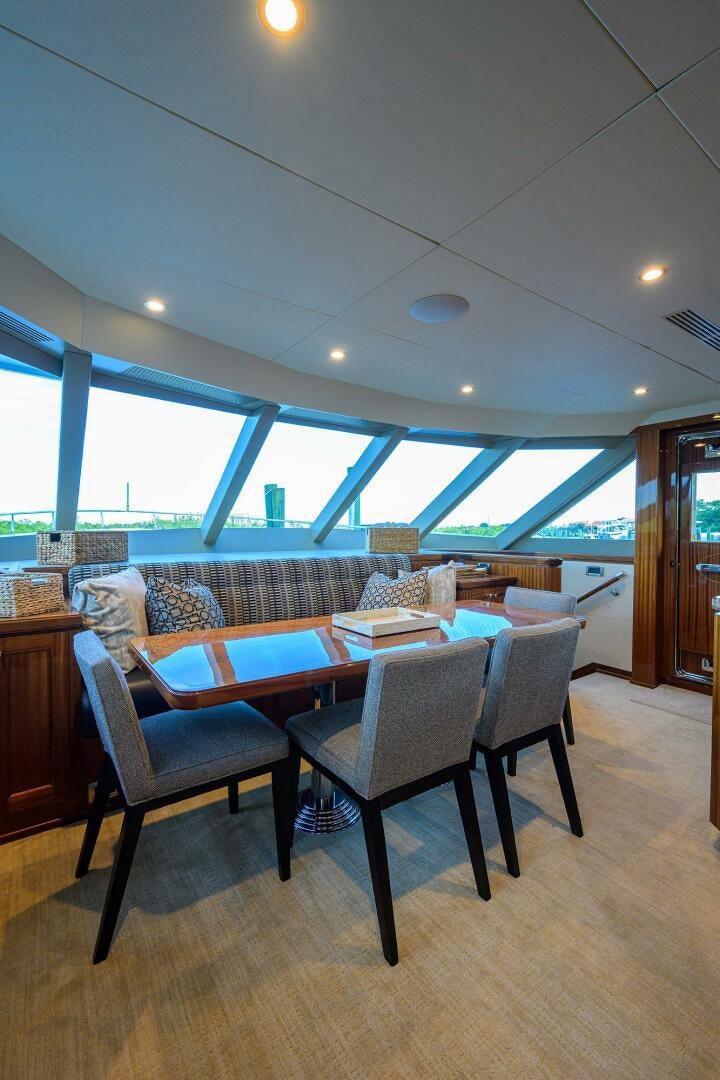 a room with a table and chairs aboard JANE E Yacht for Sale