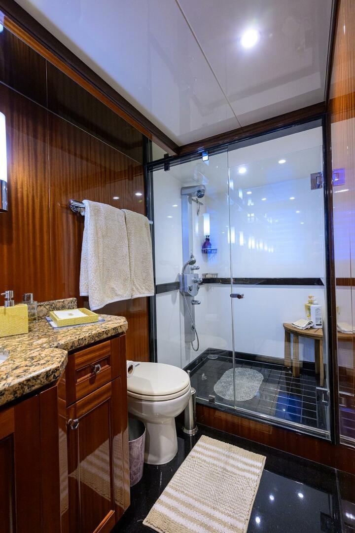 a bathroom with a glass shower aboard JANE E Yacht for Sale
