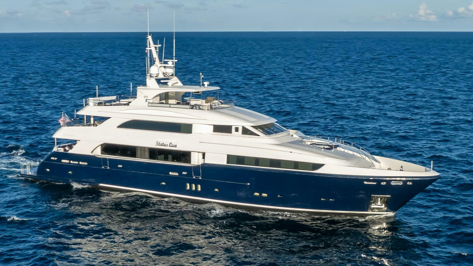 a large white yacht in the water aboard STATUS QUO Yacht for Sale