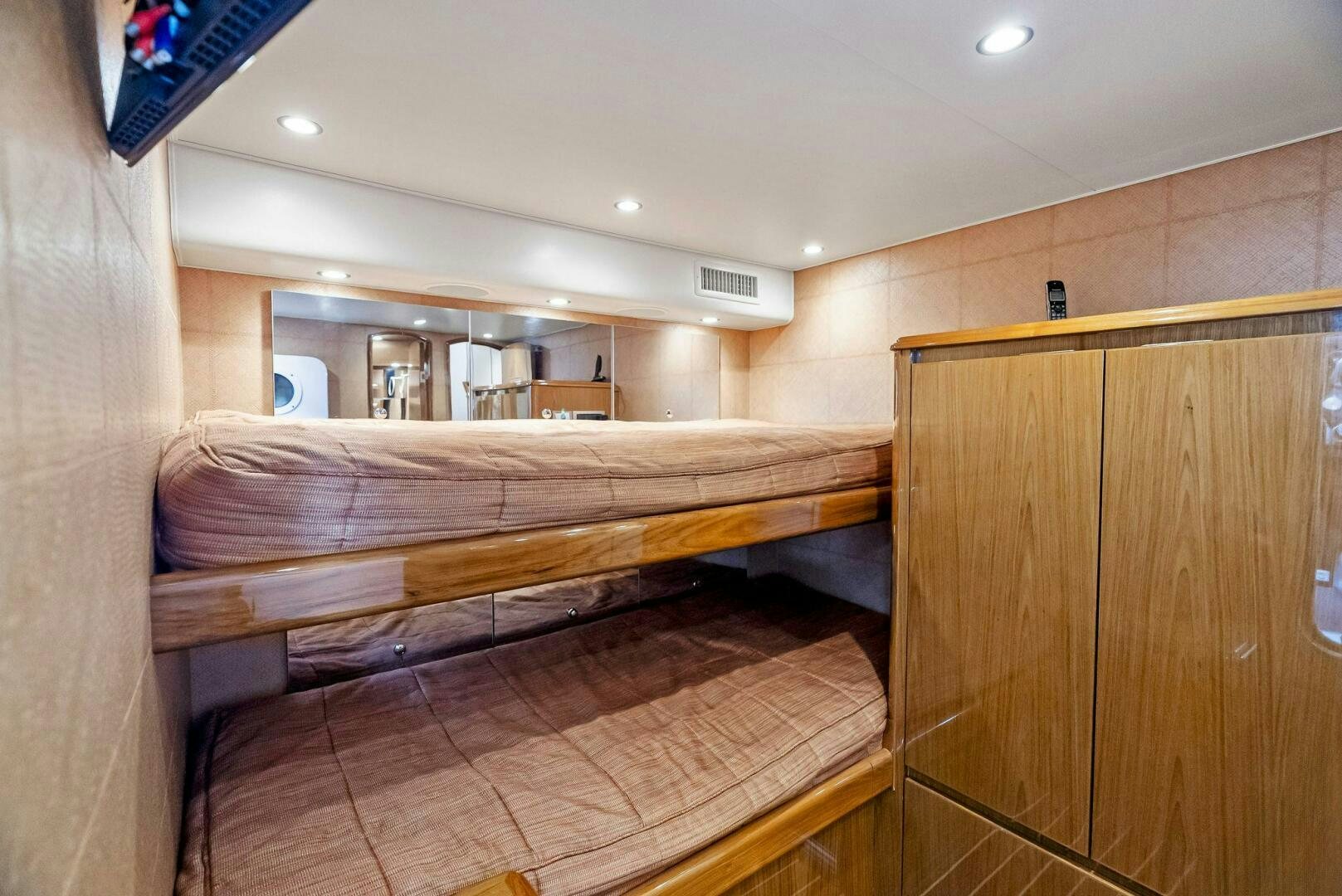 a room with a bed and a wood cabinet aboard FORTY NINER Yacht for Sale