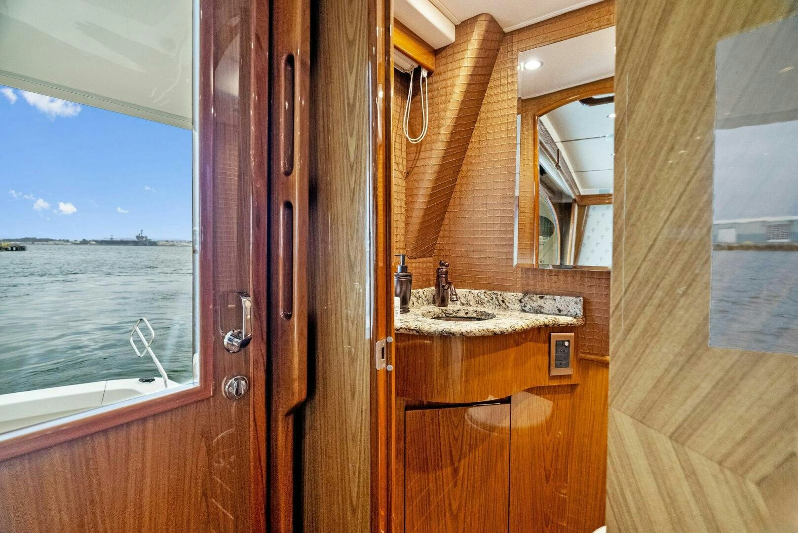 a bathroom with a wood door aboard FORTY NINER Yacht for Sale