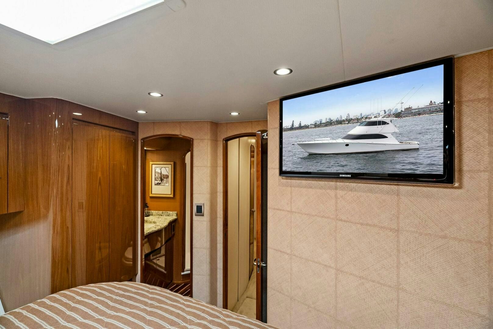 a bedroom with a large television aboard FORTY NINER Yacht for Sale