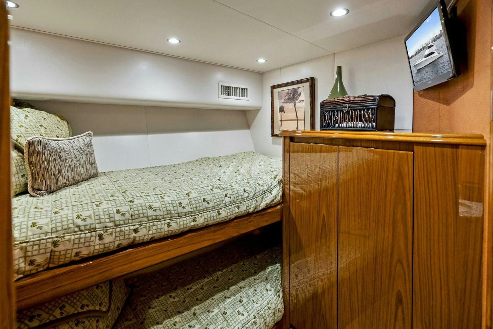 a bed with a television on the wall aboard FORTY NINER Yacht for Sale