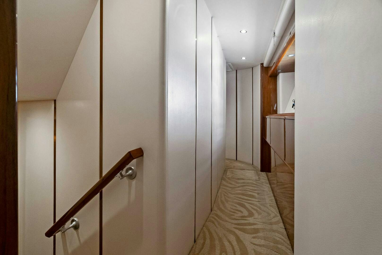 a hallway with a wood railing aboard FORTY NINER Yacht for Sale