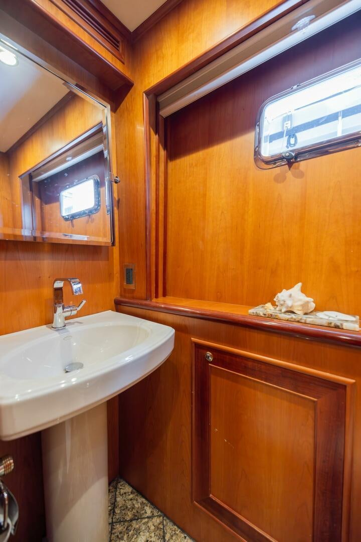 a bathroom with a sink and a mirror aboard COLETTE Yacht for Sale