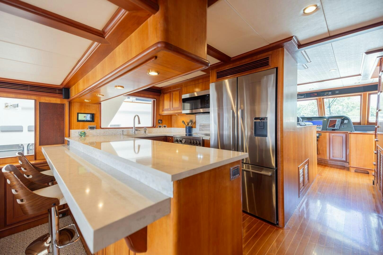 a kitchen with a stainless steel refrigerator aboard COLETTE Yacht for Sale