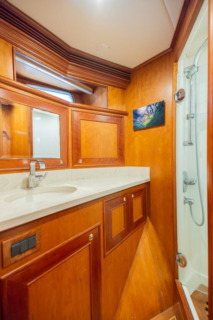 a bathroom with wooden cabinets aboard COLETTE Yacht for Sale