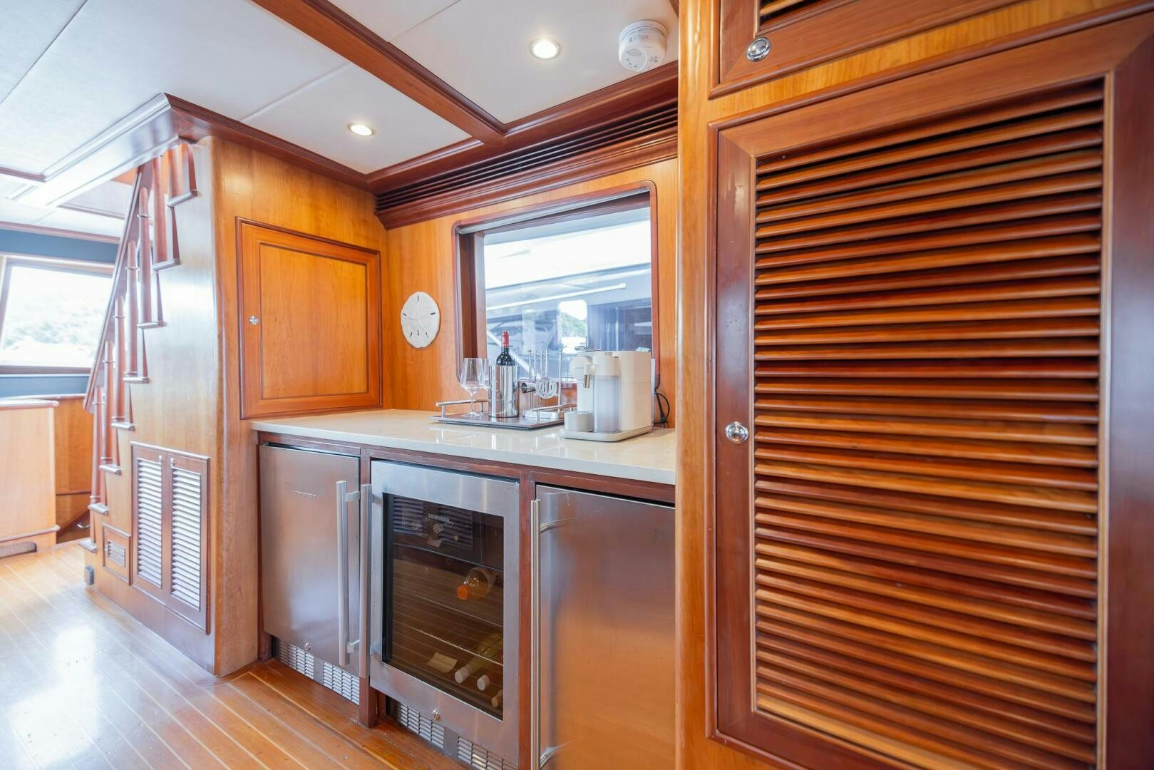 a kitchen with wooden cabinets aboard COLETTE Yacht for Sale