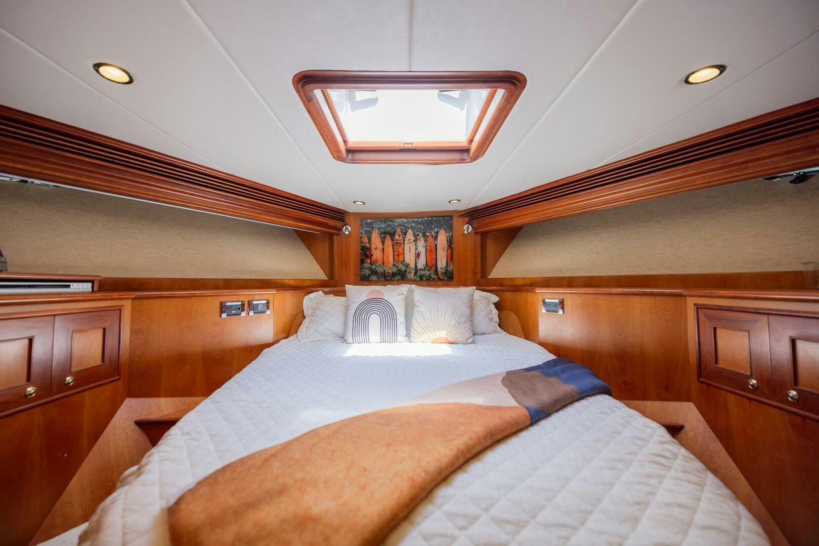 a bed with a wooden headboard aboard COLETTE Yacht for Sale