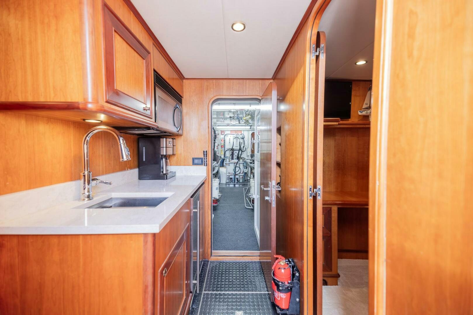 a kitchen with wooden cabinets aboard COLETTE Yacht for Sale